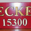 Sign in custom red with gold left letters and numbers outlined in black.