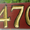 Custom two sided sign in red with gold numbers.